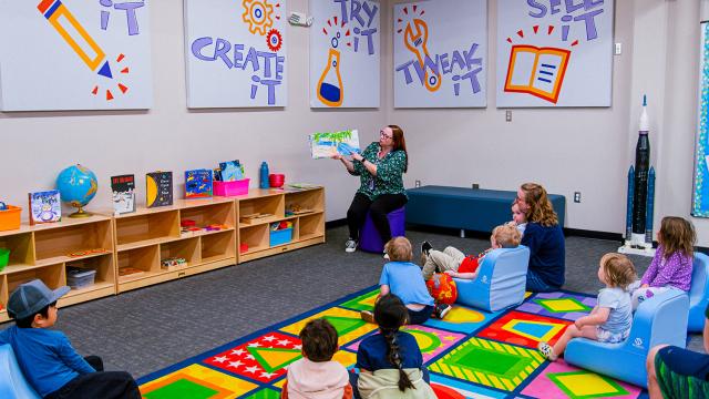 Employee reading to group of children